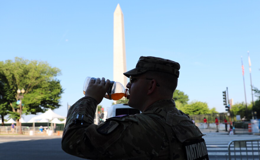 National stand guard near the Washington Monument at the national mall, during an Independence Day event honoring the nation's 250th anniversary on Saturday.