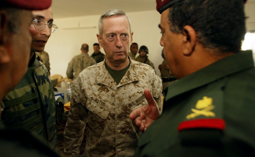 U.S. Marine Maj. Gen. James Mattis (center) talks with Iraqi Maj. Gen. Jassim Mohammed Saleh (right) during discussions held about the transfer of authority to the newly formed Fallujah Protective Army on May 2, 2004.