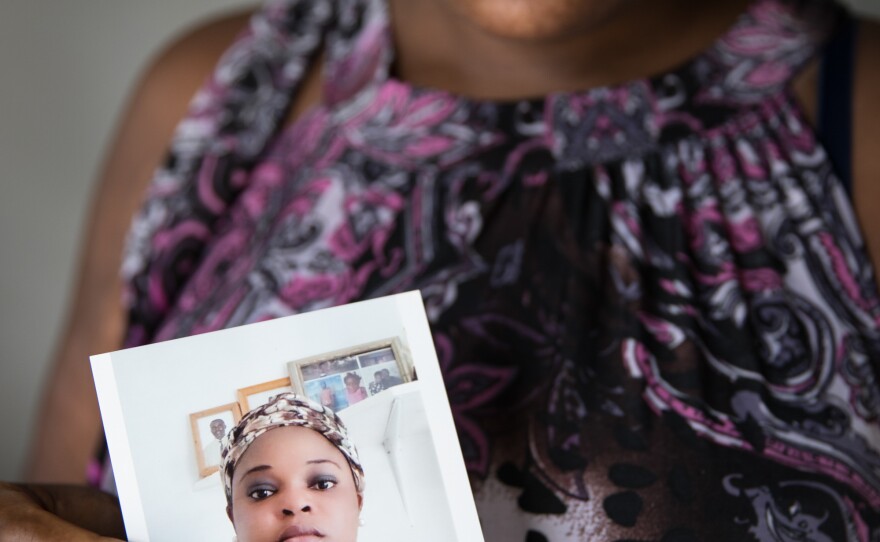 Abaco evacuee Sherrine Petit Homme LaFrance shows a photo of herself during better times. LaFrance is one of thousands of Haitians who were displaced to Nassau after Hurricane Dorian.
