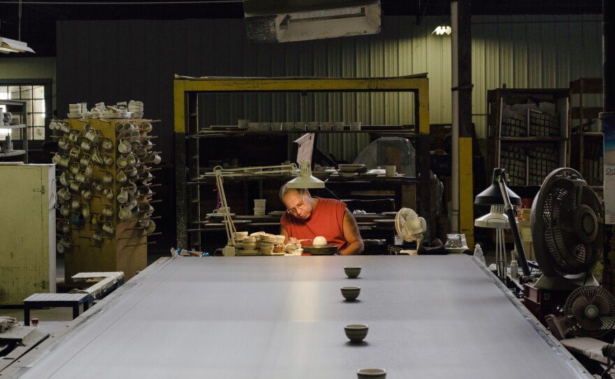 Hand liner Kevin Manypenny sends finished items down a conveyor belt to the next step on the production line. While the work he does can be automated, it's often faster to hand him the slip of the paper with the order than to reconfigure a machine.