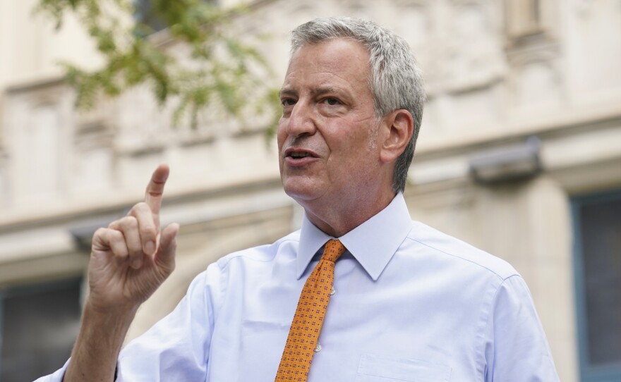 New York Mayor Bill de Blasio, shown here last month in Brooklyn, says that he and employees in his office will take furloughs to reduce costs.