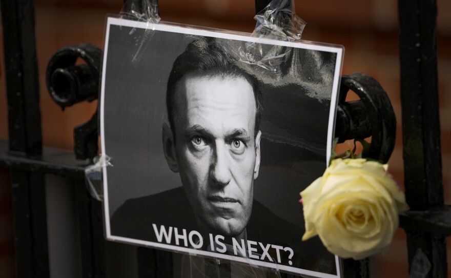 A flower and a picture are left as a tribute to Russian politician Alexei Navalny, near the Russian Embassy in London, Feb. 18.