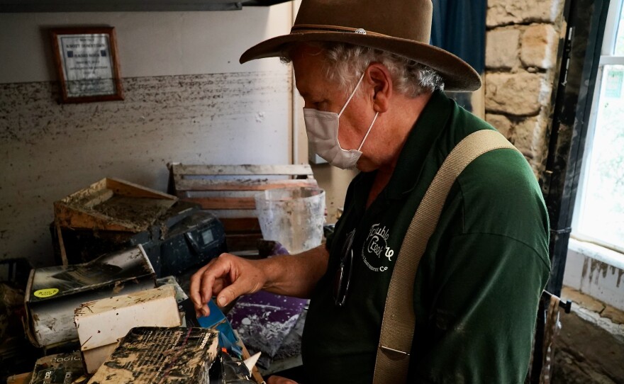 Doug Naselroad examines damaged equipment at his Appalchian School of Luthiery.