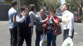 People run to safety on the streets of Mexico City after a quake measuring 7.6 according to US experts, hits Mexico, March 20, 2012. 
