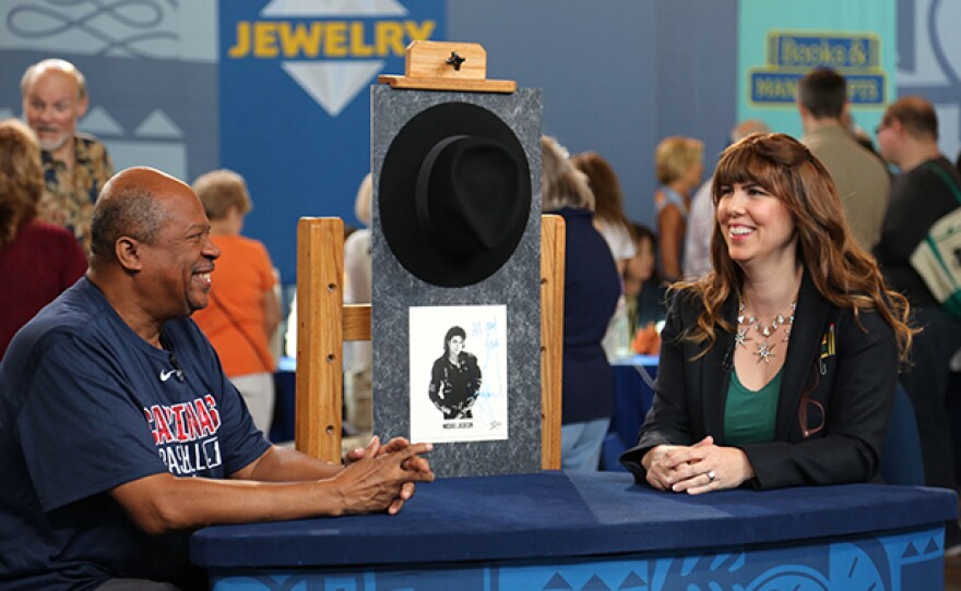 Laura Woolley (right) appraises a Michael Jackson-signed fedora and photo, ca, 1994.