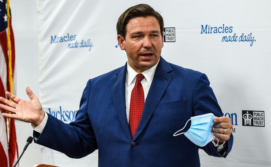 Florida Gov. Ron DeSantis speaks holding his facemask during a press conference to address the rise of coronavirus cases in the state, at Jackson Memorial Hospital in Miami, on July 13, 2020.