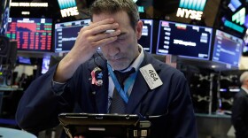 Trader Gregory Rowe works on the floor of the New York Stock Exchange, Friday, Feb. 2, 2018. 