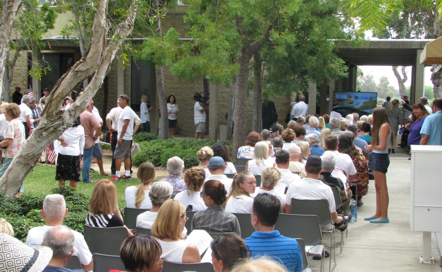 An overflow crowd fills the courtyard outside Carlsbad City Hall, as the City Council votes on a plan to build a shopping center on the shores of the Agua Hedionda Lagoon, Aug. 25, 2015.