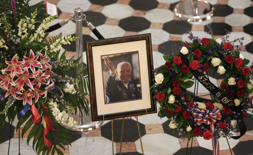 The Air Force says it is investigating allegations that an employee at the military mortuary at Dover Air Force Base offered to show the remains of John Glenn to Defense Department inspectors. Above, a photo of the former astronaut and U.S. senator as he lay in state at the Ohio Statehouse in December 2016.