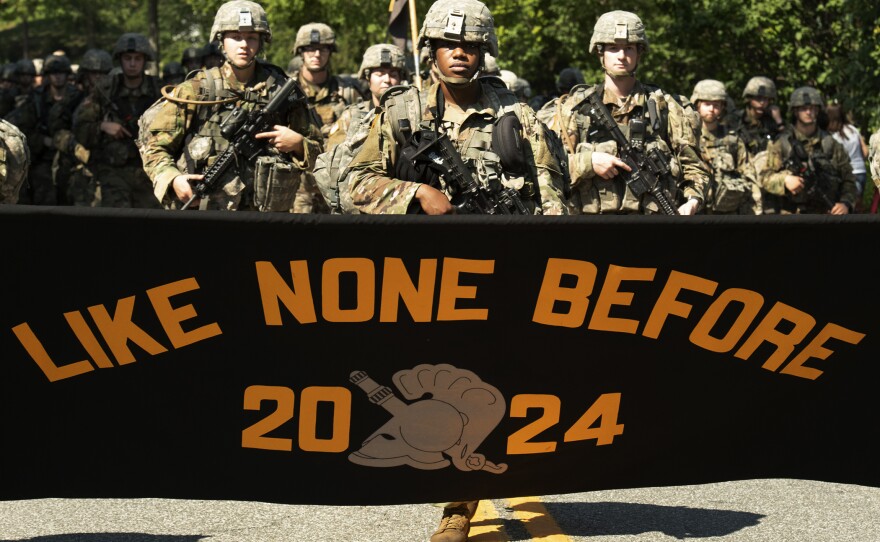 Senior Evan Walker, cadet basic training commander, marches with freshmen as they display their motto on a 12-mile march after finishing up four weeks of basic training on Monday in West Point, N.Y.