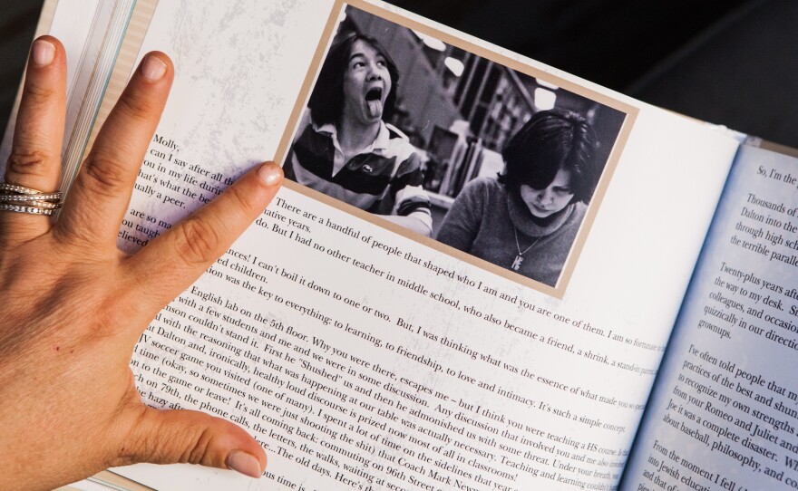 Pollak pages through the book of letters from her former students.