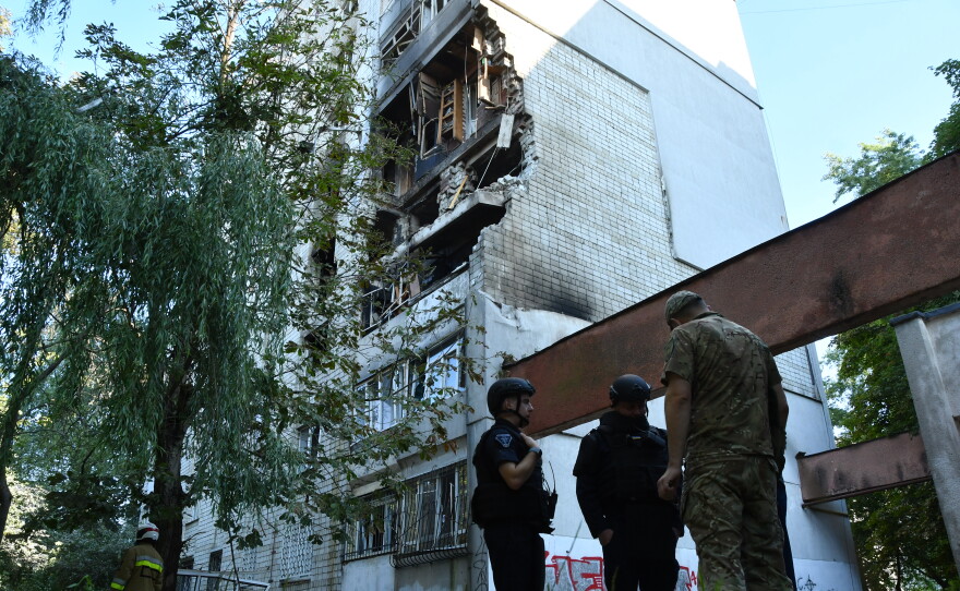 Rescuers work at the damaged apartment building following a Russian air attack in Lviv, Ukraine, Thursday, July 30, 2026.