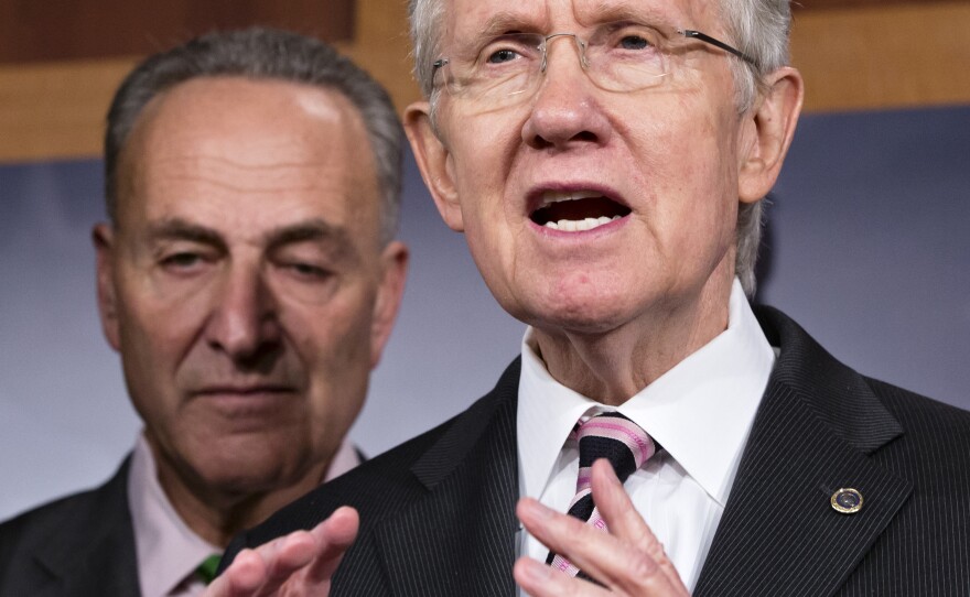 Senate Majority Leader Harry Reid, accompanied by Sen. Charles Schumer, D-N.Y., tells reporters that Republicans need to "get a life and talk about something" other than Obamacare.