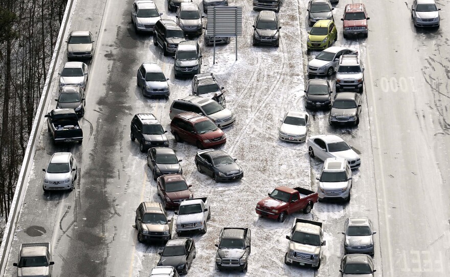 Abandoned cars sit on Interstate 75 in Atlanta. Traffic halted Tuesday during an ice and snow storm. Two days later, drivers can start retrieving their vehicles.