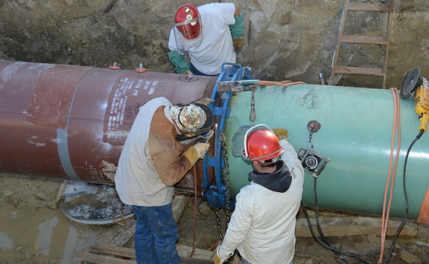 Pipefitters work on construction of the Keystone XL Pipeline's southern portion outside Tulsa, Okla., last January.