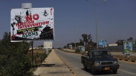 A sign declaring  "No foreign intervention, Libyan people can do it alone" stood outside the airport in Benghazi, Libya, on Monday.