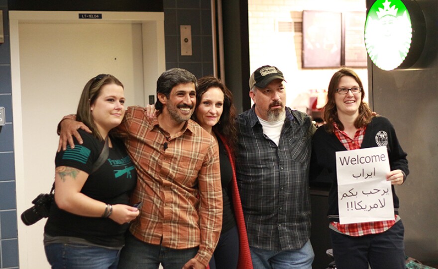 Interpreter Phillip Morris (second from left) and Paul Braun (second from right) with friends at the airport.