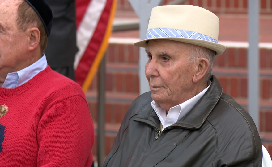 Holocaust survivor Ben Midler is shown wearing a tan hat in front of the county administration building on December 22, 2025.