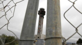 A fence secures the perimeter of a half-completed 236-foot FAA control tower at Oakland International Airport. Construction has been halted because of the FAA shutdown.