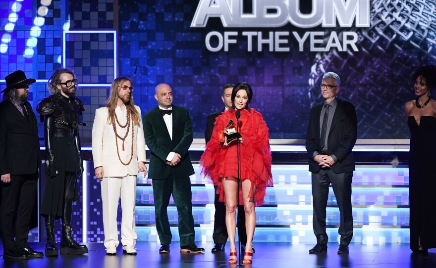 Kacey Musgraves (speaking at microphone) won the Grammy for Best Album of the Year for Golden Hour.