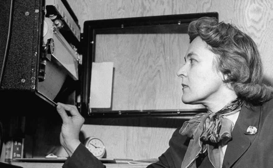 Inside a newly designed solar-heated house, Dr. Mária Telkes adjusts the energy levels. (1940-1949).