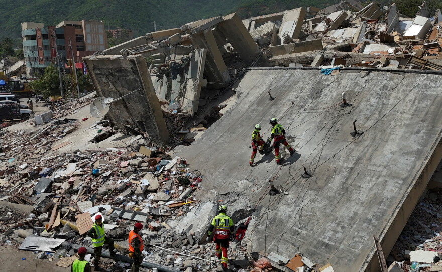 Mexican Army rescue workers search for people trapped in collapsed buildings after earthquakes struck La Guaira, Venezuela, Sunday, June 28, 2026.