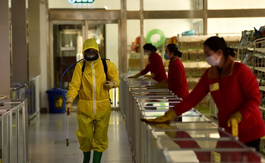 Employees spray disinfectant and wipe surfaces as part of preventative measures against the coronavirus at the Pyongyang Children's Department Store in March.
