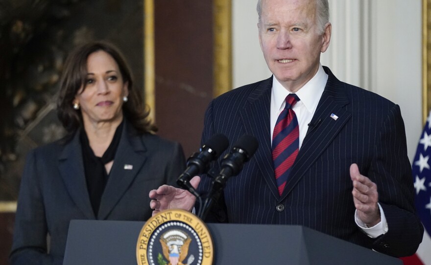 Vice President Kamala Harris listens as President Joe Biden speaks before signing the Consolidated Appropriations Act for Fiscal Year 2022 in the Eisenhower Executive Office Building on Tuesday, March 15, 2022. Harris' office later announced that her husband, second gentleman Douglas Emhoff, had tested positive for COVID-19.