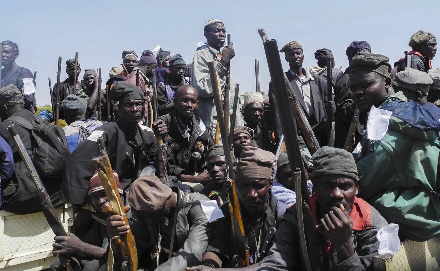 A group of Nigerian traditional hunters and vigilantes gather on vehicles on their way to engage Boko Haram militants in Mubi from Yola, Adamawa State, in November. The hunters have being assisting the Nigerian military in their fight against the Islamic insurgents.