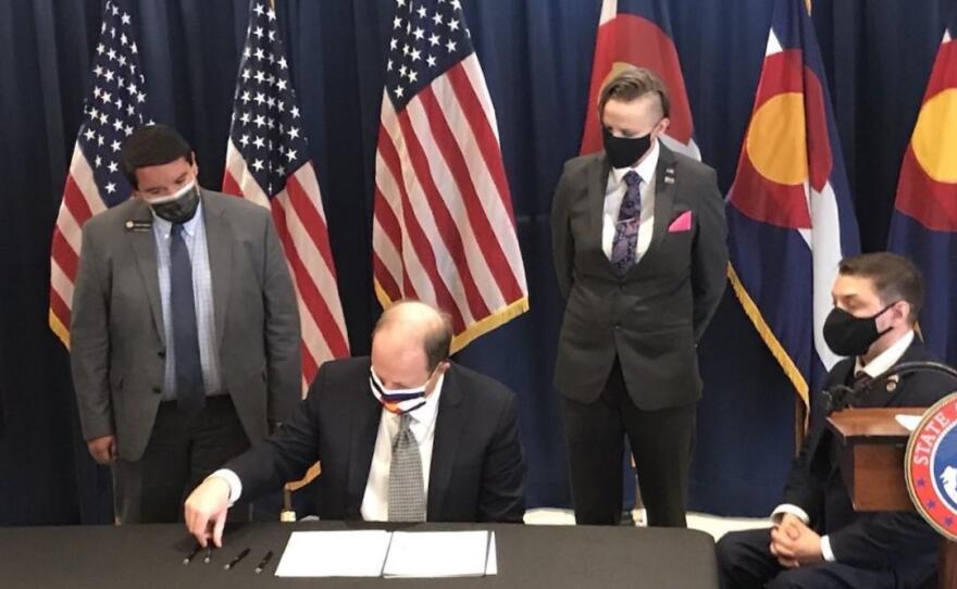 Colorado Governor Jared Polis signs the Restoration of Honor Act in April, expanding state veterans benefits to former service members who were expelled for being gay.