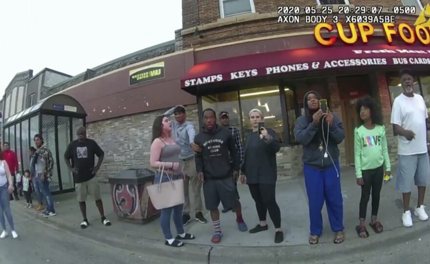 A police body camera image shows bystanders including Darnella Frazier (third from right filming) as former Minneapolis police officer Derek Chauvin was recorded pressing his knee on George Floyd's neck in Minneapolis.