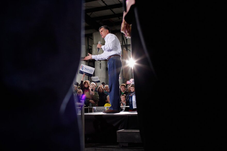 Former Massachusetts Gov. Mitt Romney addresses supporters during a campaign rally at the Weber Paper Company Monday in Dubuque, Iowa.