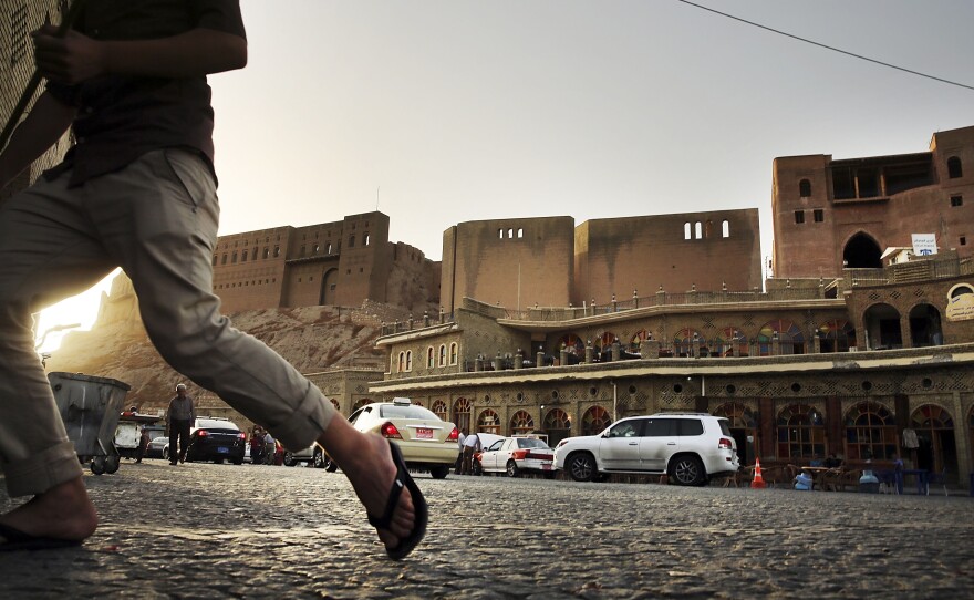 People walk near the Citadel in Erbil last June.