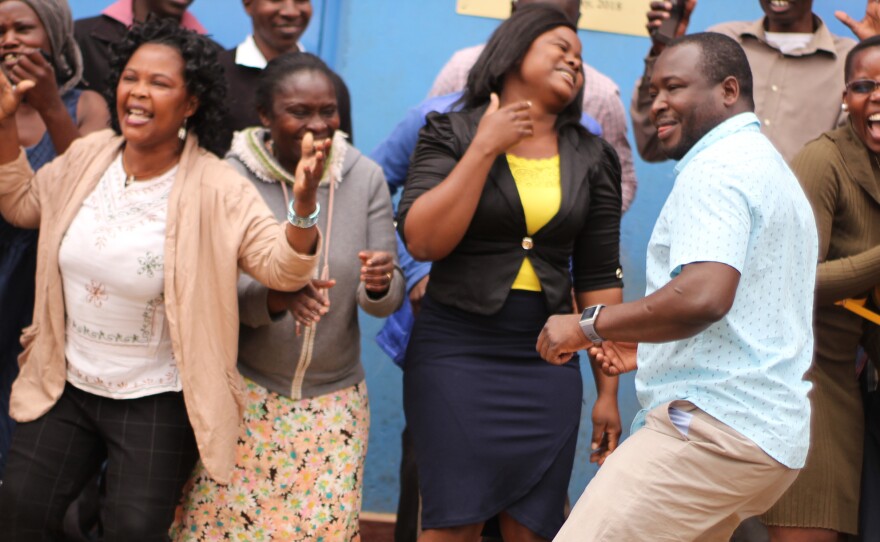 Kennedy Odede (in blue shirt) is dancing for a good reason. The charity he and his wife started has been awarded the $2 million Hilton Humanitarian Prize. He's joined by residents of Kibera, the neighborhood in Nairobi where his nonprofit group provides educational, health and clean water services.