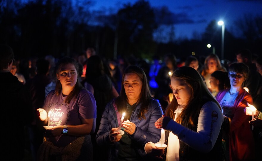 People gather at a vigil in Lisbon Falls, Maine, on Saturday for the victims of the mass shooting.