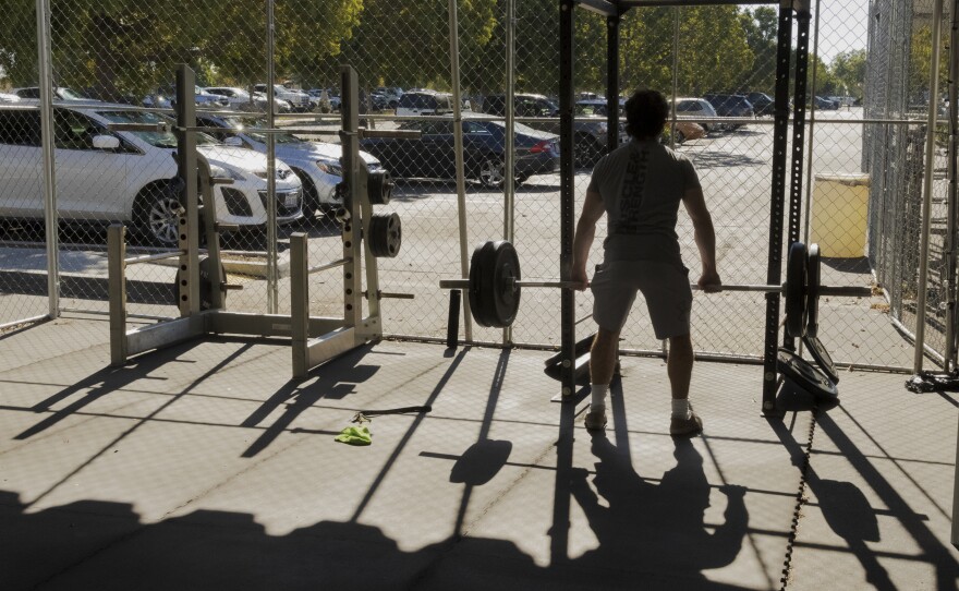 Point Loma resident Nate Dimelfi lifts weights at Point Loma Sports Club's parking lot gym. Nov. 11, 2020.