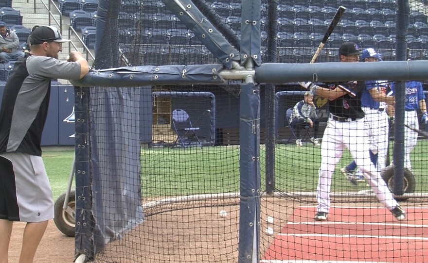 John Peabody (left) helps a player with his swing, June 9, 2016.
