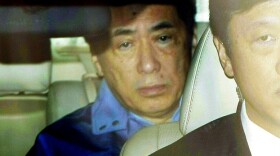Prime Minister Naoto Kan leaves the headquarters of the Tokyo Electric Power Co. after meeting with the company's staff Tuesday.