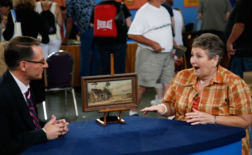 David Weiss (left) appraises a William Aiken Walker oil painting, found within a pile of trash, for $7,000 to $10,000 in the ANTIQUES ROADSHOW special "Finders Keepers."