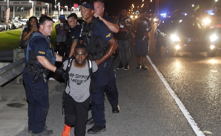 Police arrest activist DeRay Mckesson on Saturday, during a protest along Airline Highway, a major road that passes in front of the Baton Rouge Police Department headquarters in Baton Rouge, La.