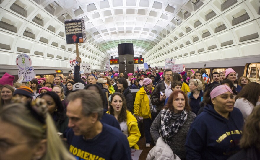 Protesters arrive at the Capital South Metro station for the Women's March on Washington in Washington, DC.