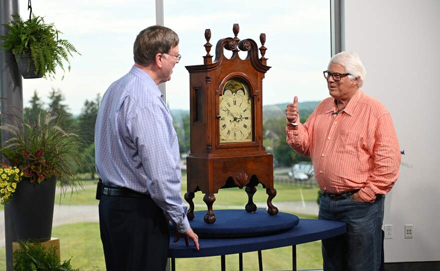 Gary Sullivan (left) appraises a Pennsylvania walnut shelf clock, ca. 1795, in Shelburne, VT.