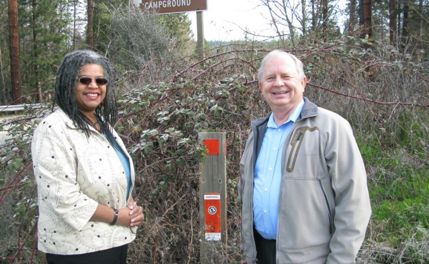 Dero Forslund (right), Trinity County's chief executive, and Connie Stewart, executive director of the California Center for Rural Policy, stand near a marker showing where AT&T fiber runs underground.
