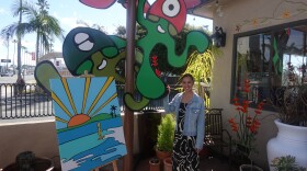 Bella Bowman with her art, "Bob the Blob" (left) and "Fun Guys" (right), in front of Carrillo Pottery in Oceanside on Jan. 26, 2026.