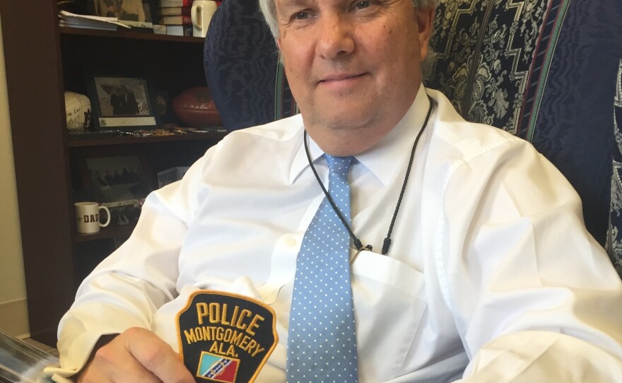 Montgomery Public Safety Commissioner Chris Murphy holds the city's police patch — the same one that officers wore when they arrested Rosa Parks and Martin Luther King.