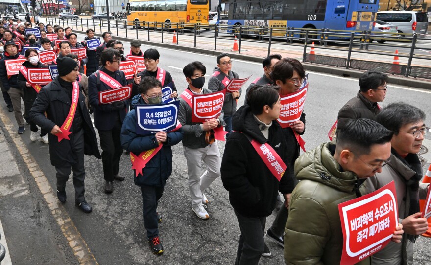 Doctors are shown marching toward the Presidential Office during a rally to protest against the government's plan to raise the annual enrolment quota at medical schools, in Seoul on Feb.25, 2024.