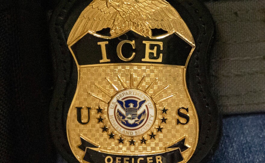 FILE - A federal agent wears an Immigration and Customs Enforcement badge, June 10, 2025, in New York.