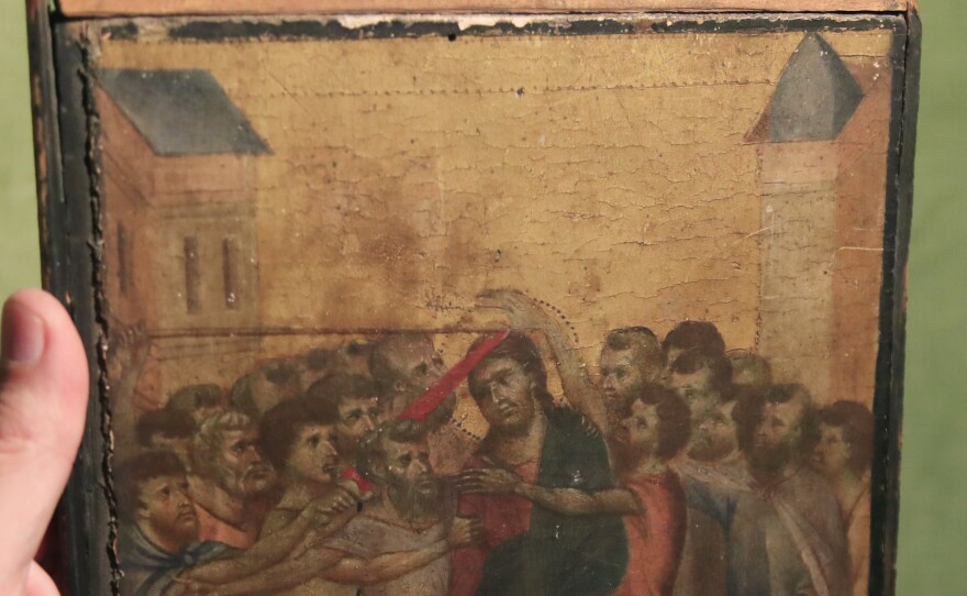Art expert Stéphane Pinta points to a 13th century painting by Italian master Cimabue in Paris.