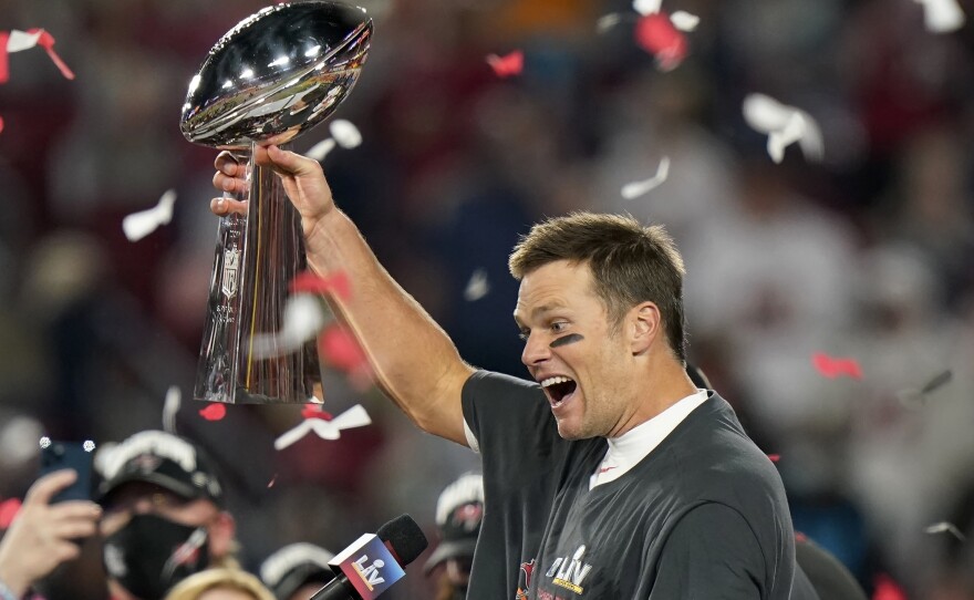 Tampa Bay Buccaneers quarterback Tom Brady celebrates with the Vince Lombardi Trophy after the team's NFL Super Bowl 55 football game against the Kansas City Chiefs in Tampa, Fla.