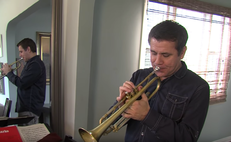 Gilbert Castellanos plays the trumpet in his Normal Heights home, Feb. 20, 2017. 